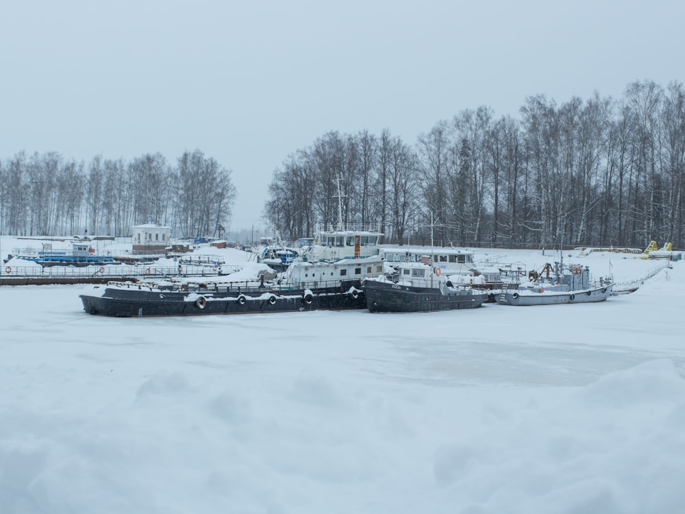 a couple of boats that are sitting in the snow