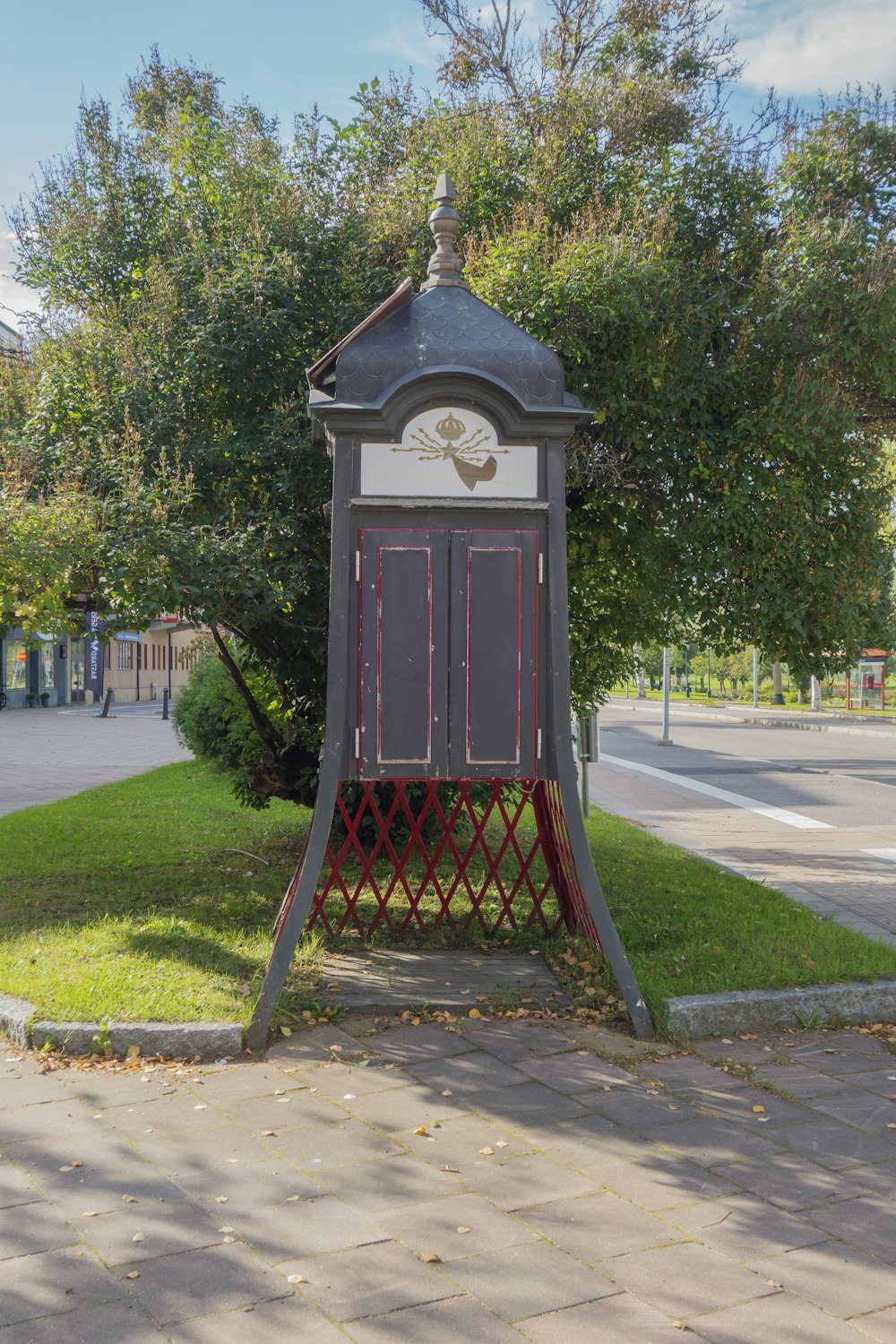 a clock tower sitting in the middle of a park