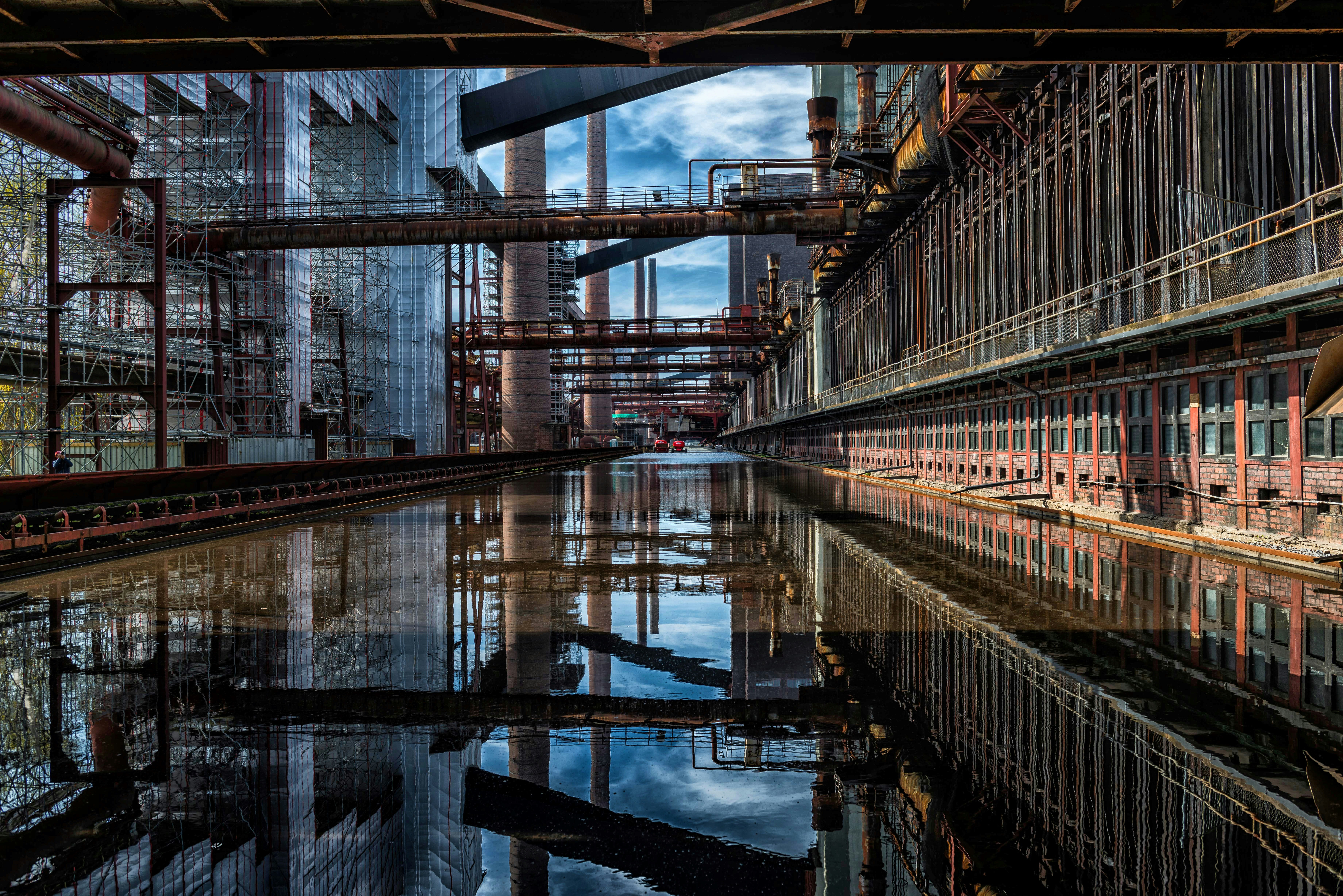 an industrial area with a body of water in the foreground