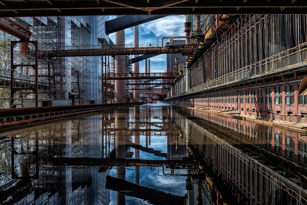 an industrial area with a body of water in the foreground