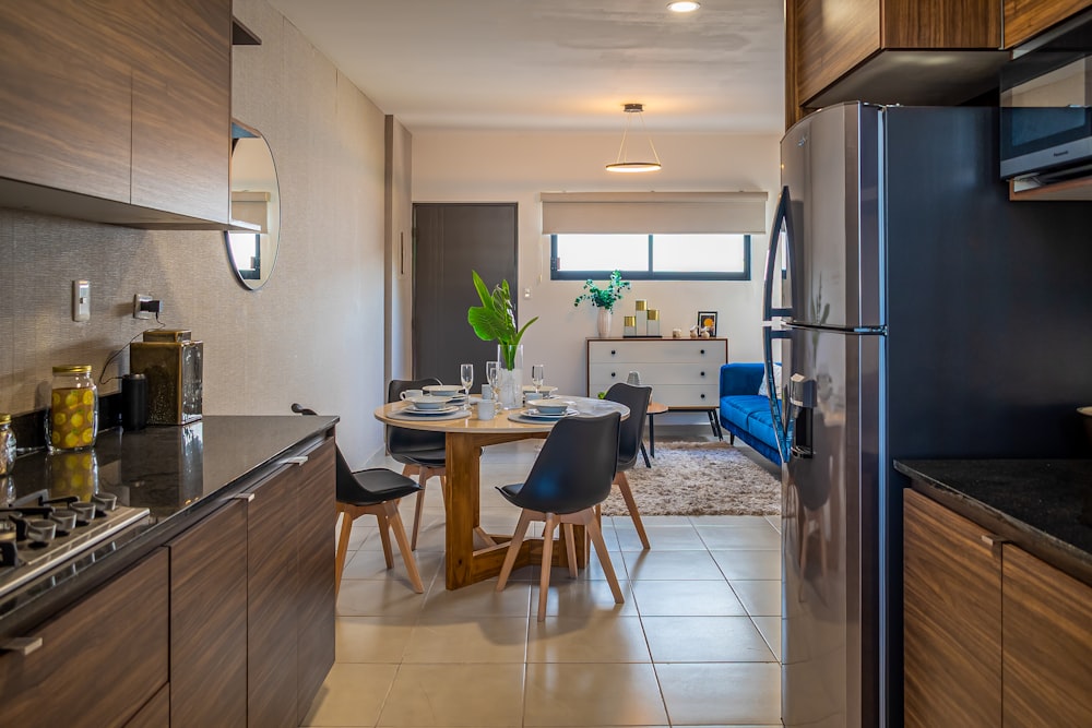 a kitchen with a table and chairs and a refrigerator