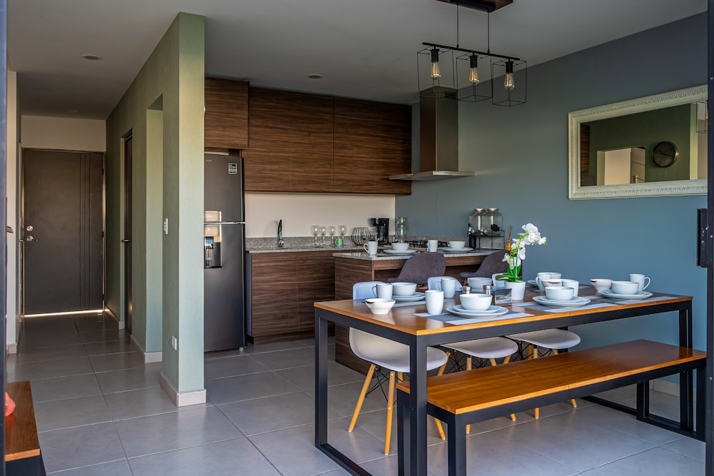 a kitchen with a table and a bench in it