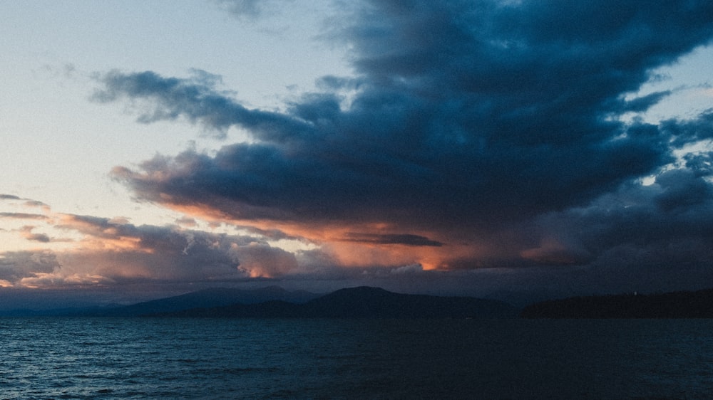 a large body of water under a cloudy sky