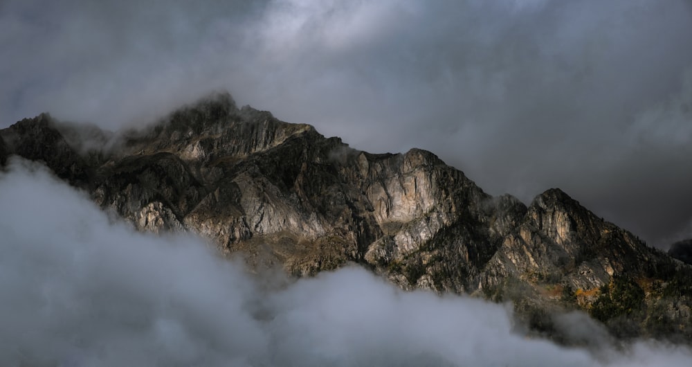 una montaña cubierta de nubes bajo un cielo nublado