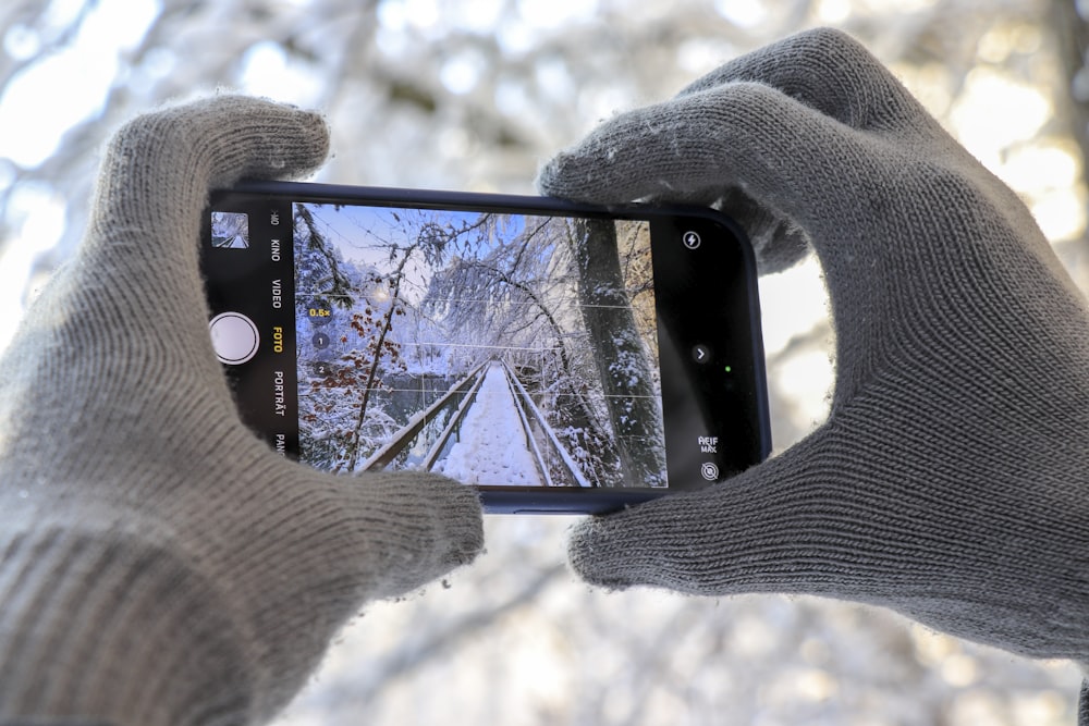 a person taking a picture with a cell phone