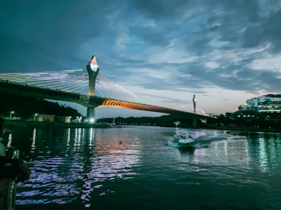a boat is in the water near a bridge