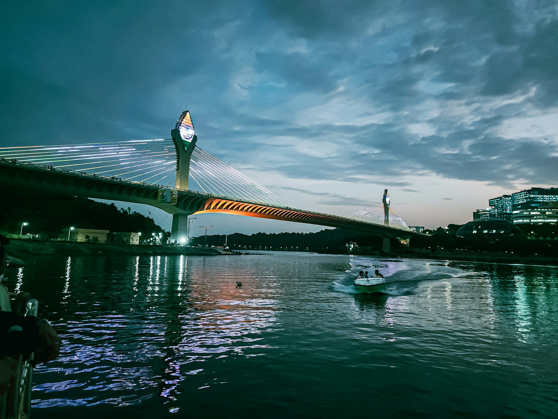 a boat is in the water near a bridge