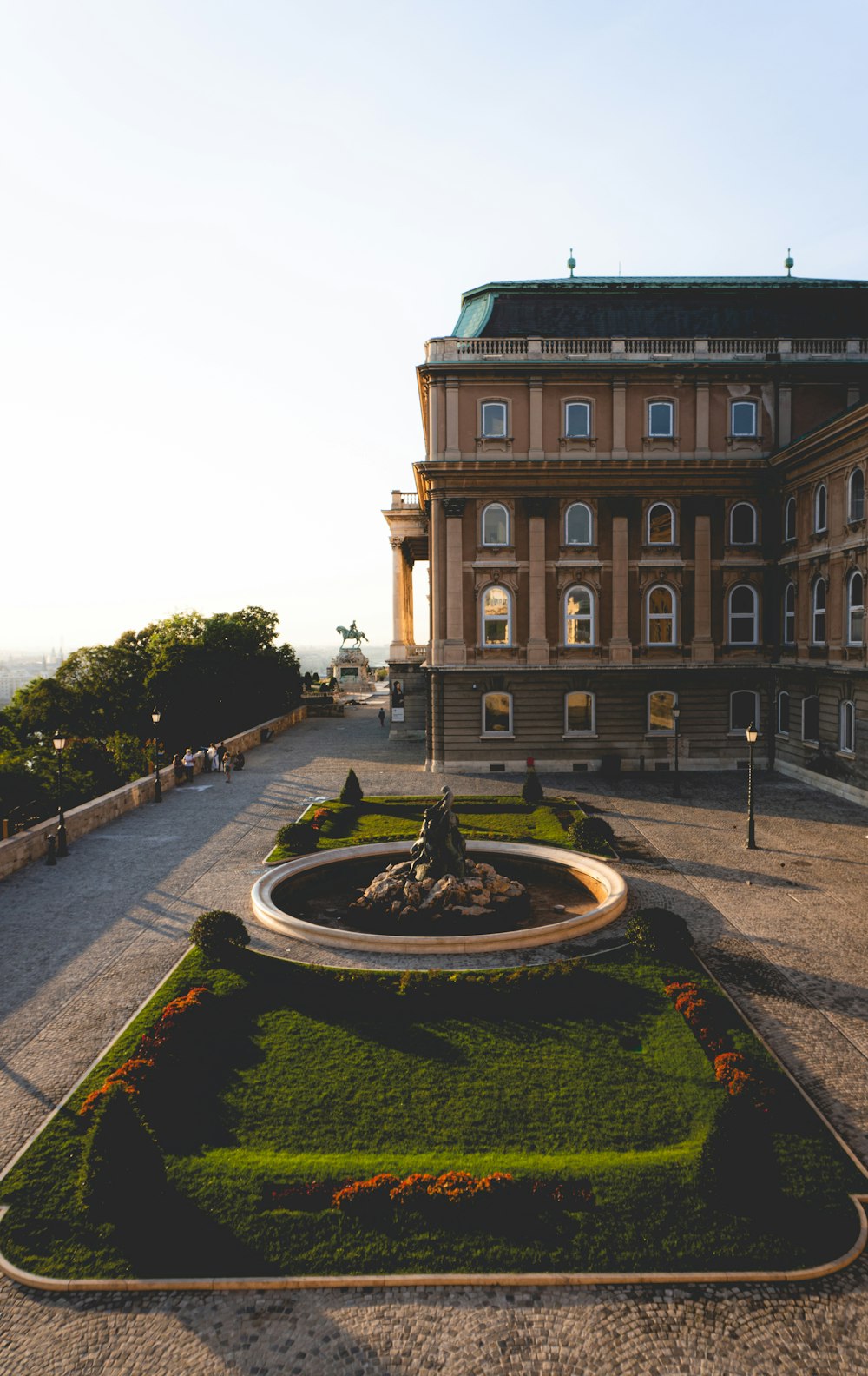 a large building with a fountain in front of it