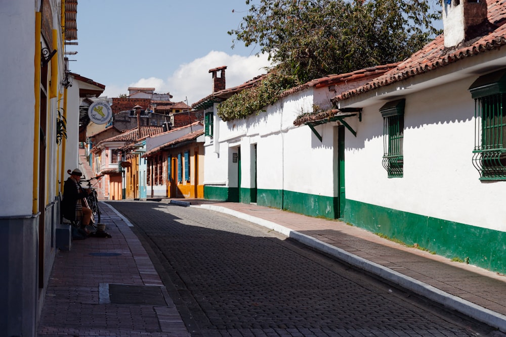 a person sitting on a bench on a street