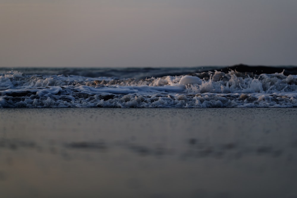 a close up of a wave on a beach