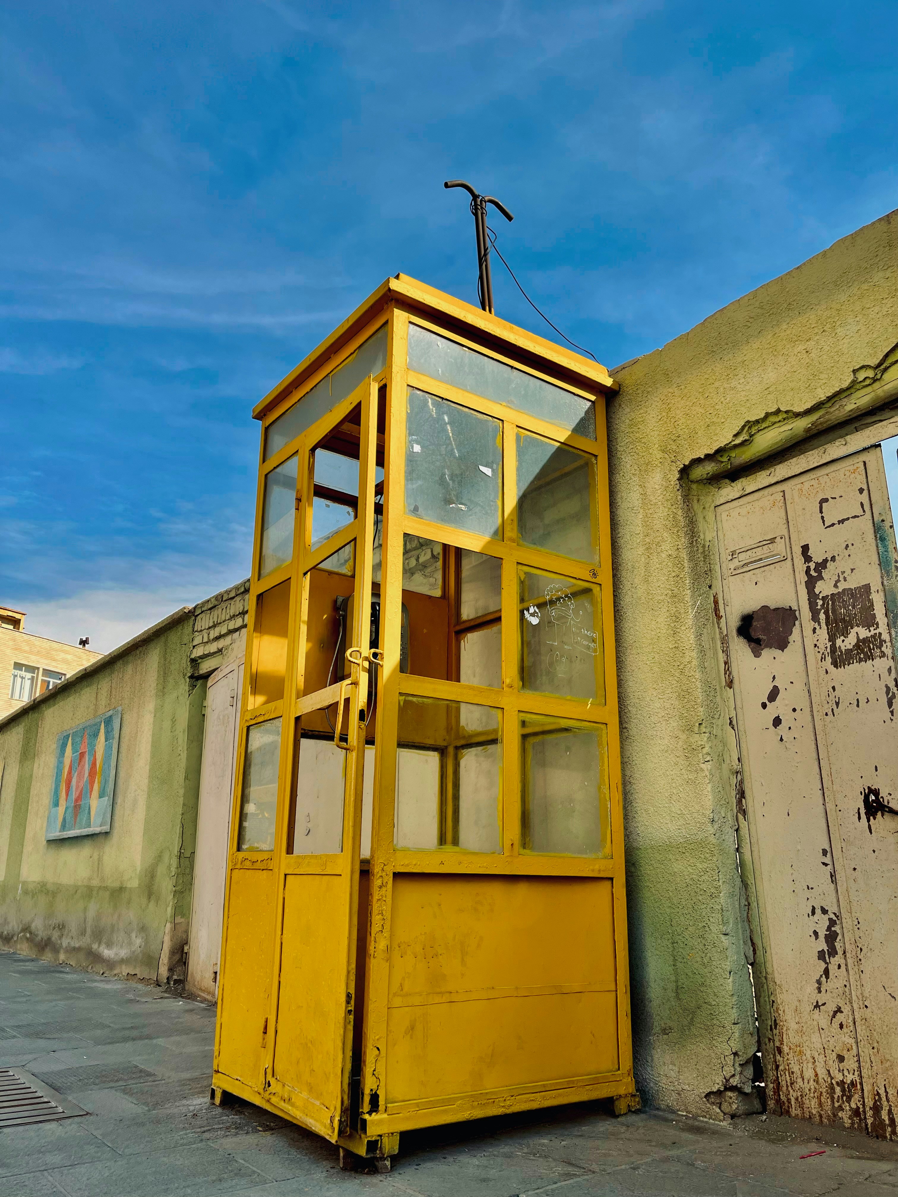 a yellow door with a cross on top of it
