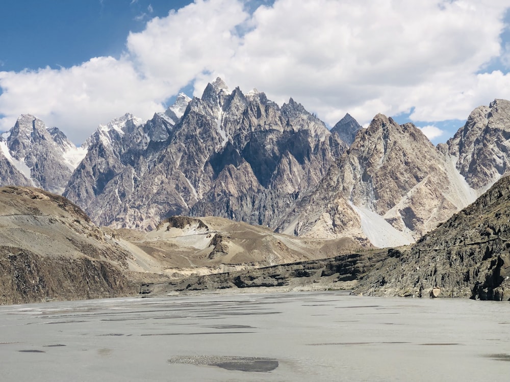 a mountain range with a body of water in the foreground