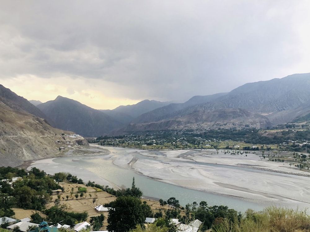 a river running through a valley surrounded by mountains