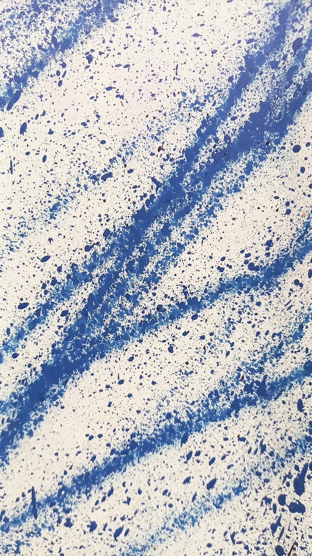 a snow covered ground with blue lines in the snow
