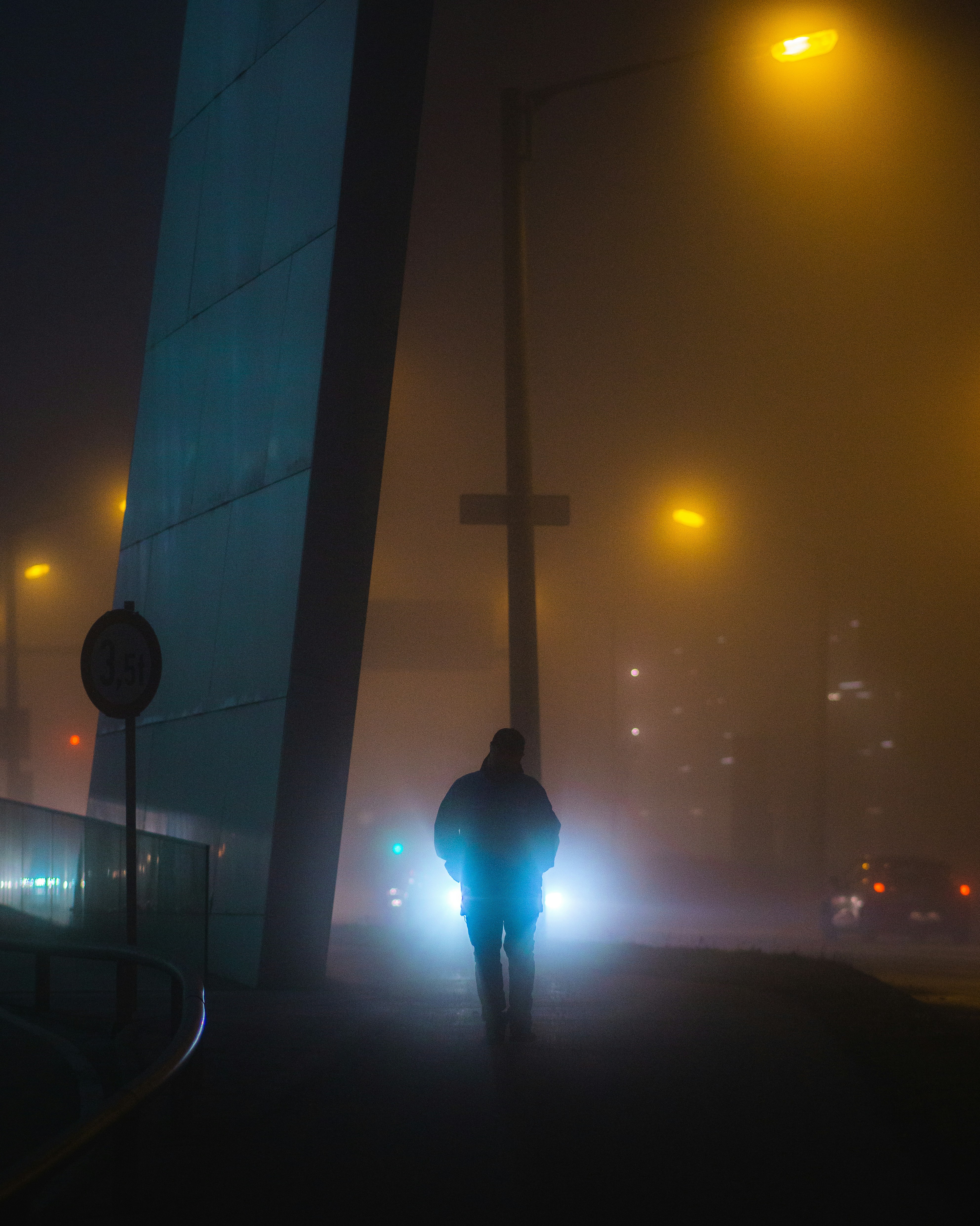 a person walking down a street at night