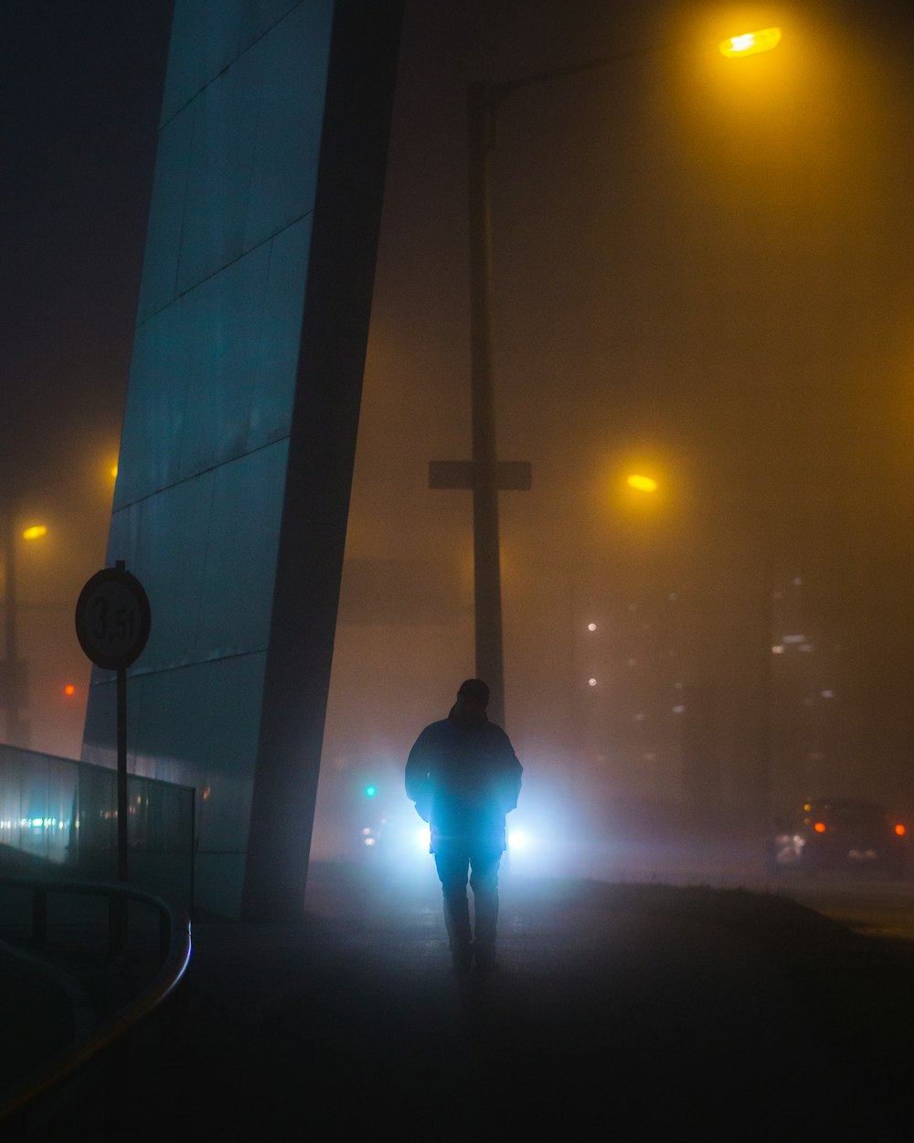 a person walking down a street at night