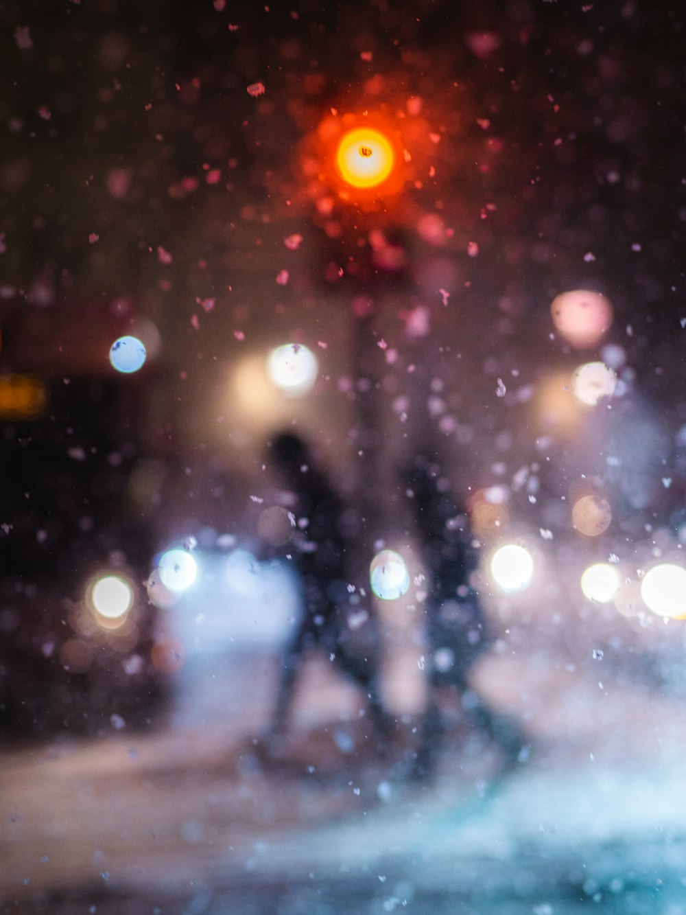 a blurry image of people walking in the rain