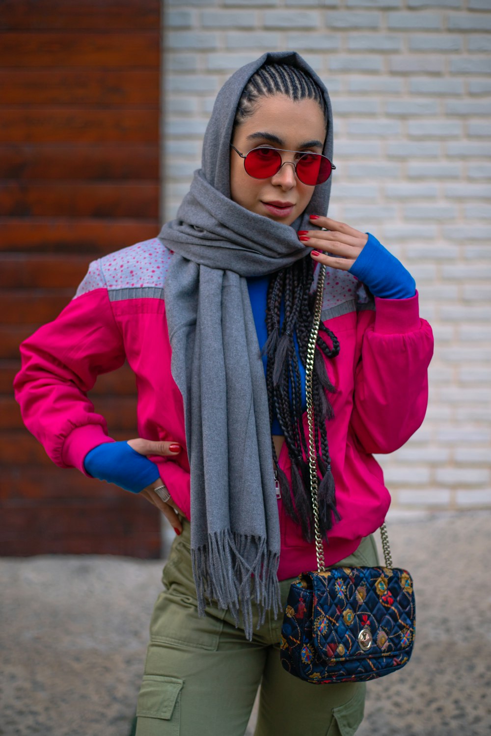 a woman wearing a pink jacket and scarf