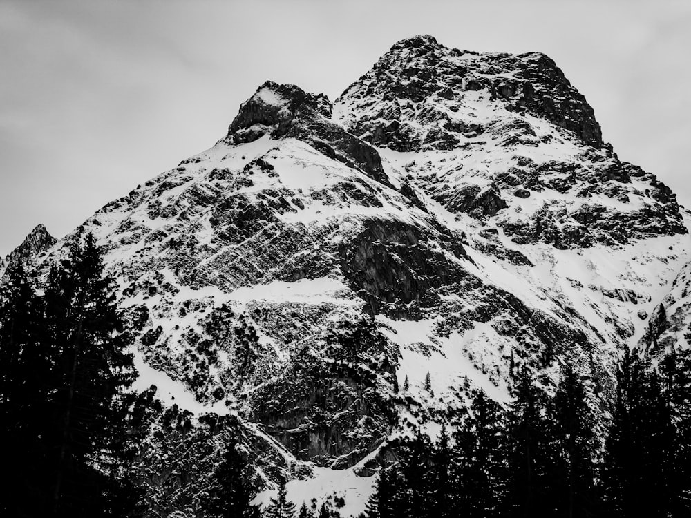 a black and white photo of a snow covered mountain