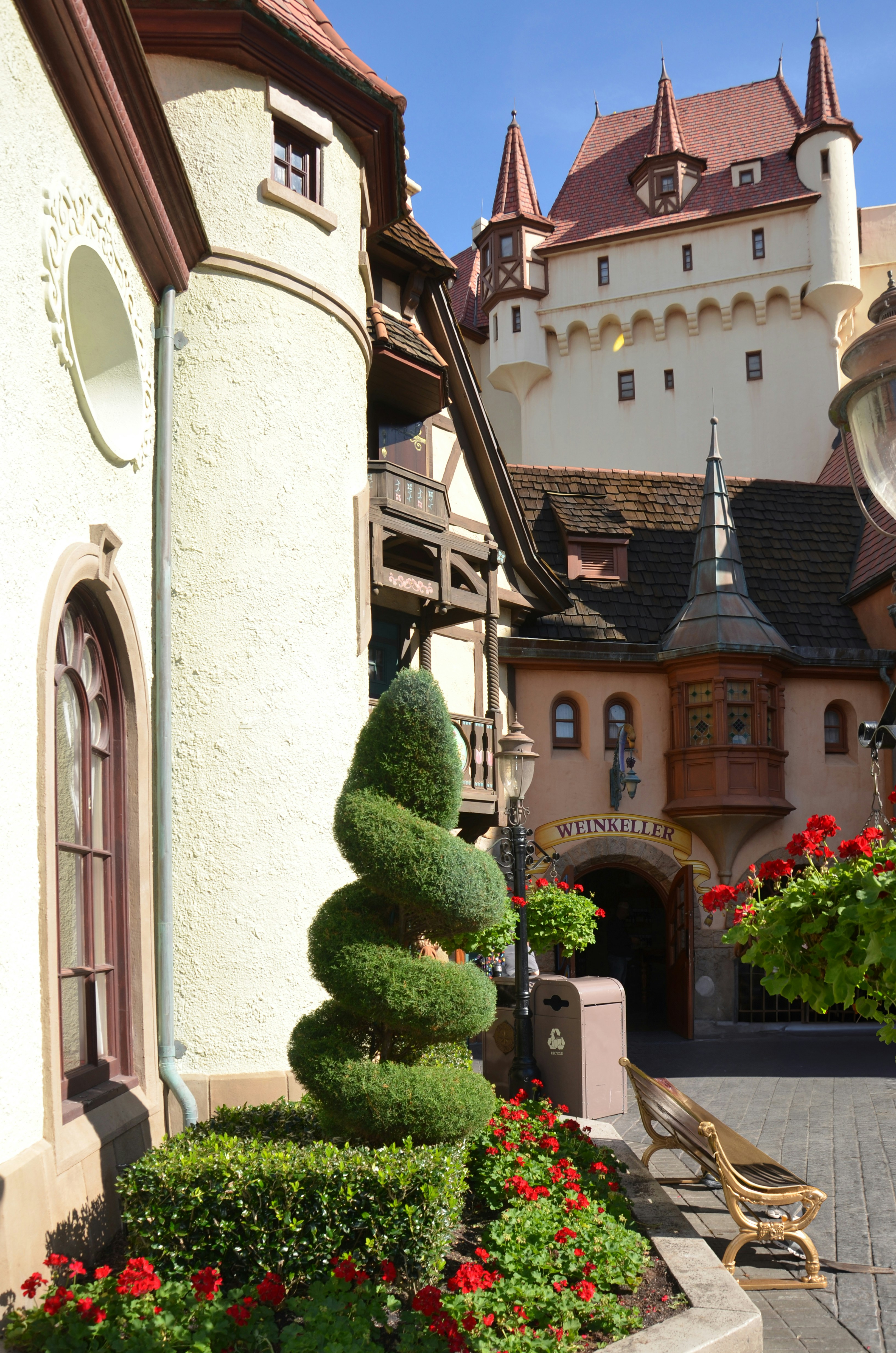 a building with a tower and a garden in front of it