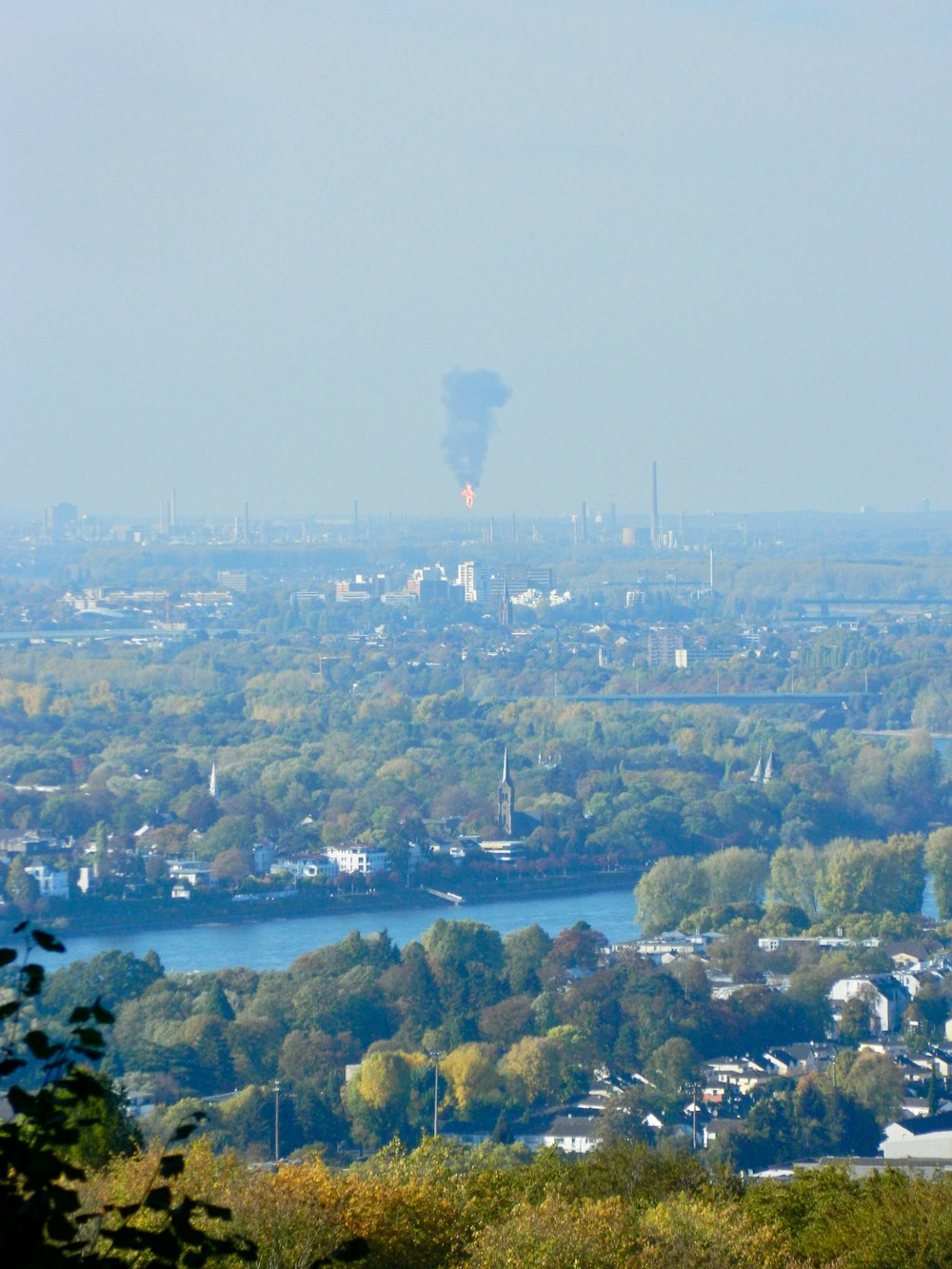 a view of a city and a river from a hill