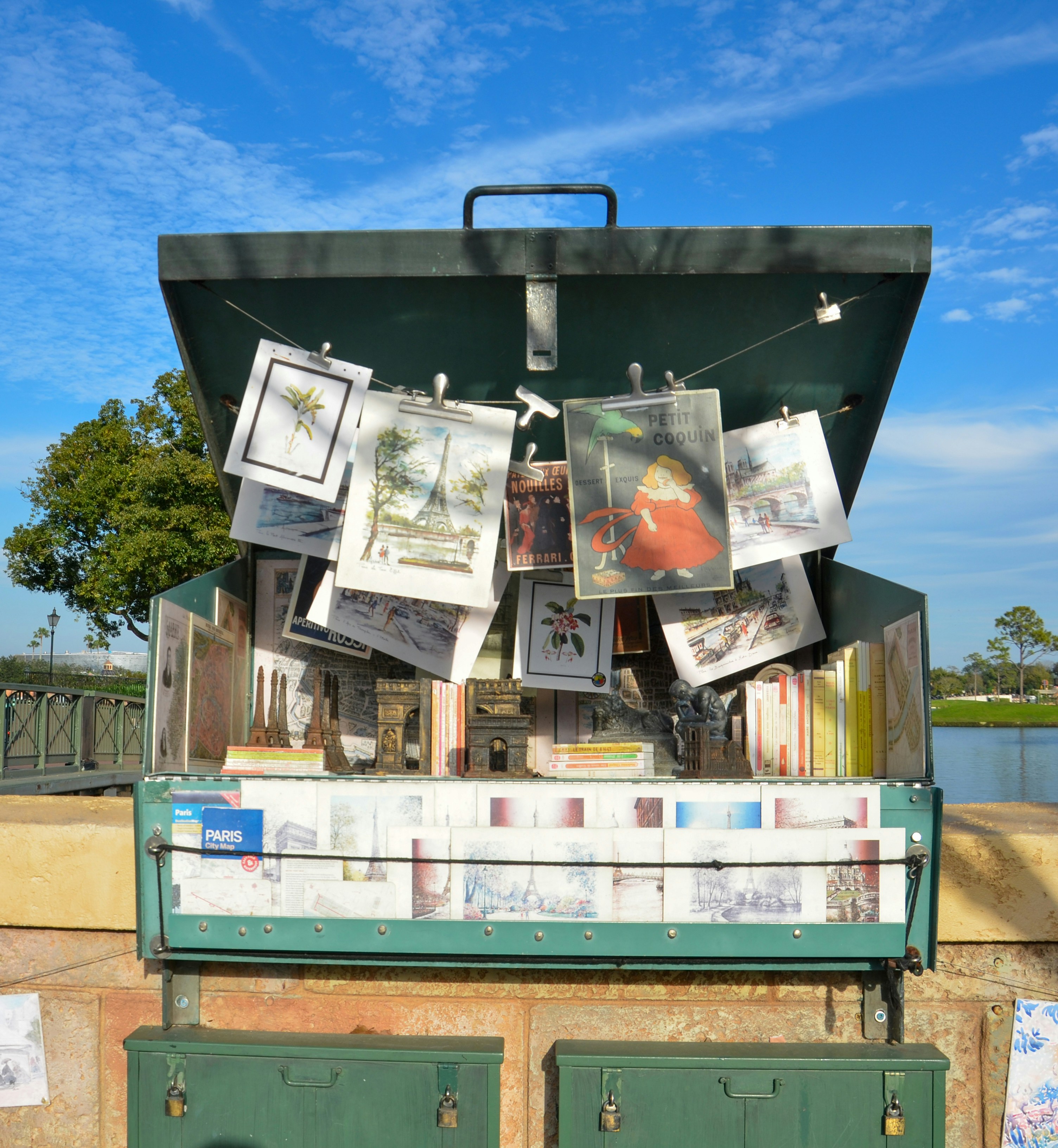 a green suitcase with pictures hanging from it