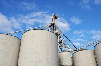 a group of silos sitting next to each other under a blue sky