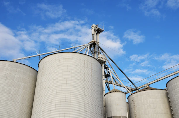 a group of silos sitting next to each other under a blue sky