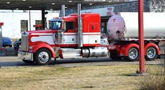 a red and white truck parked in a parking lot