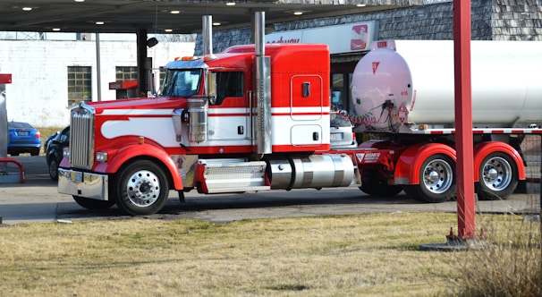 a red and white truck parked in a parking lot