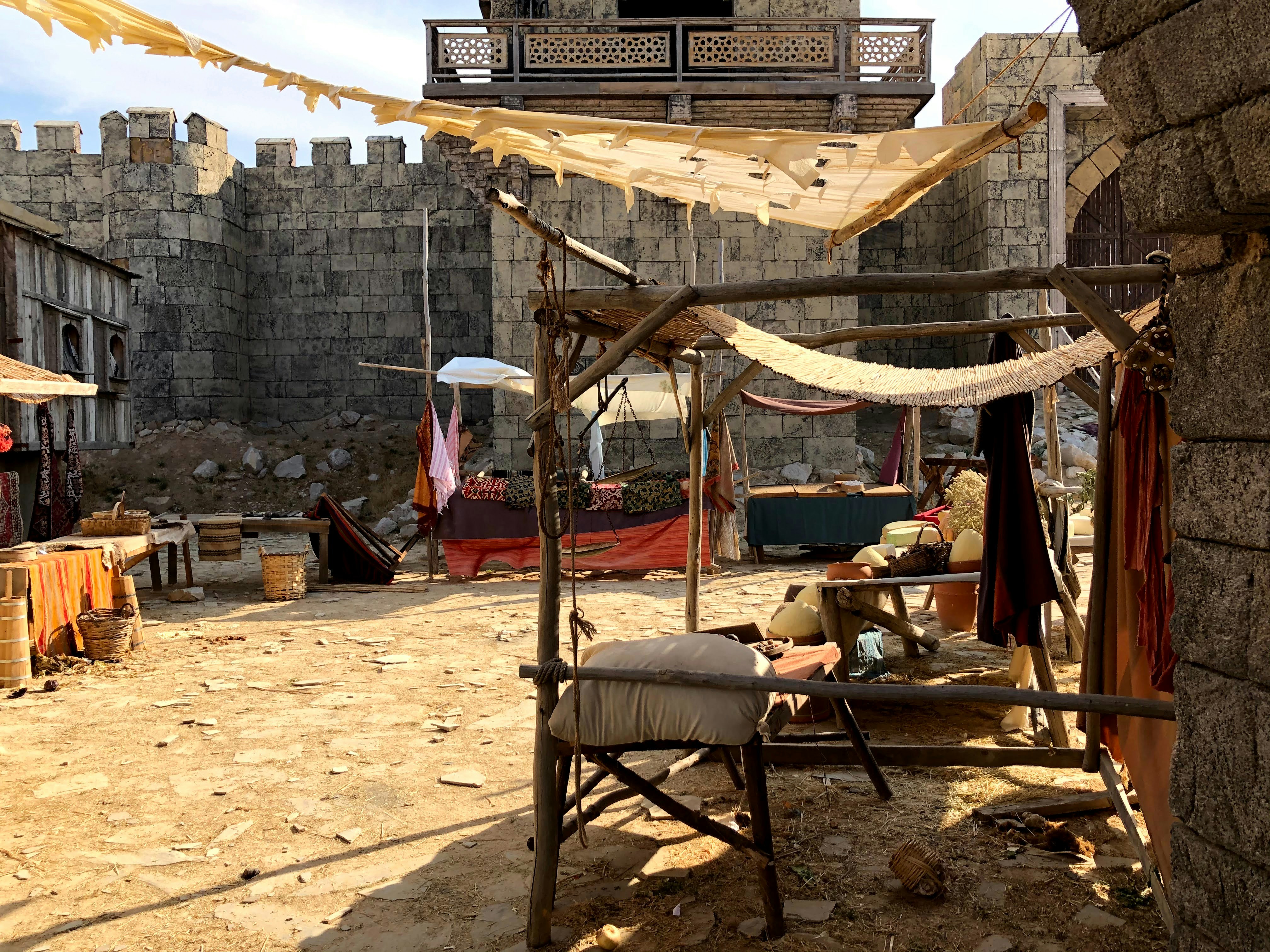 a man sitting on a chair in front of a building, Ottoman