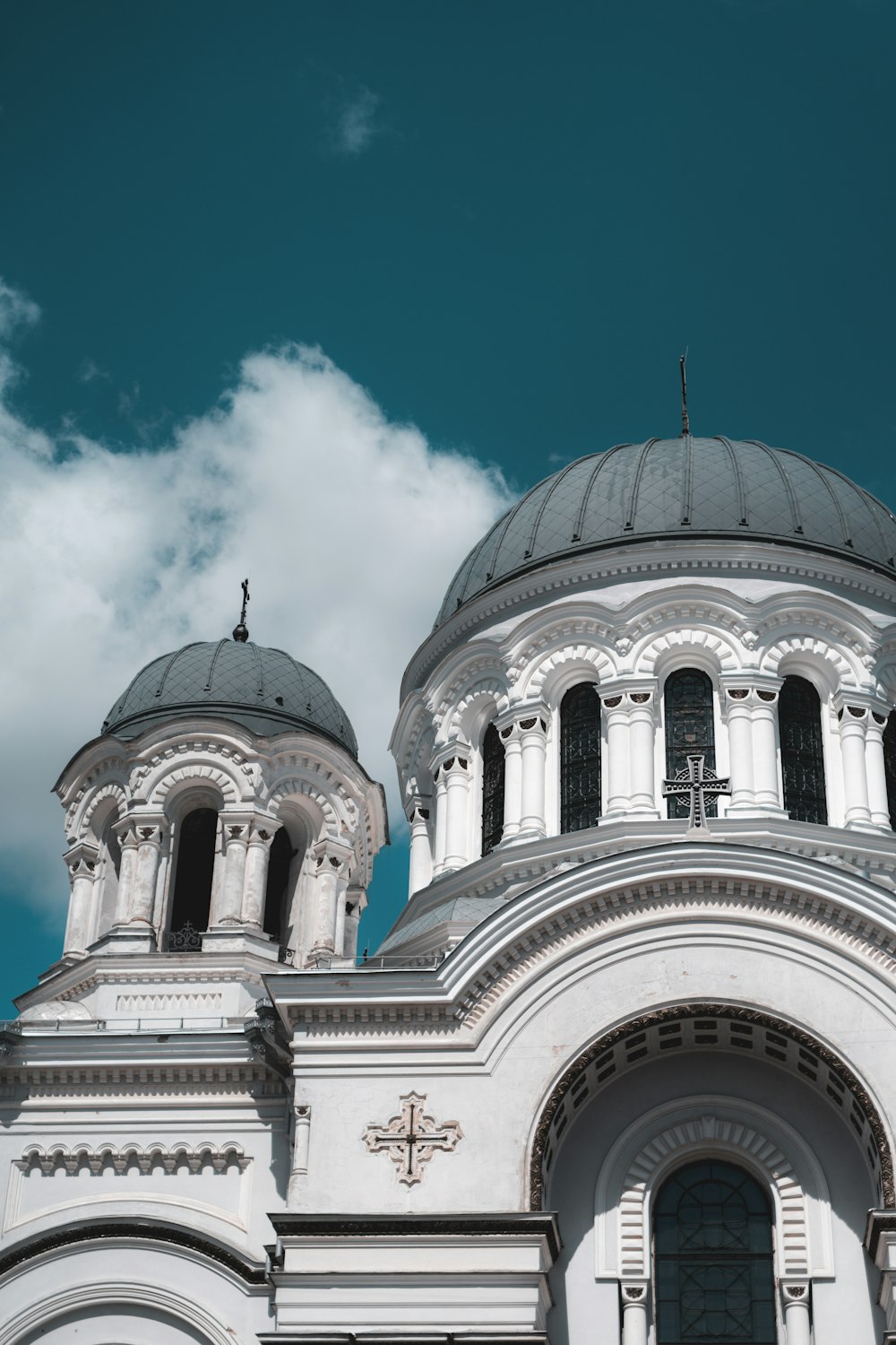 a large white building with a cross on it's roof