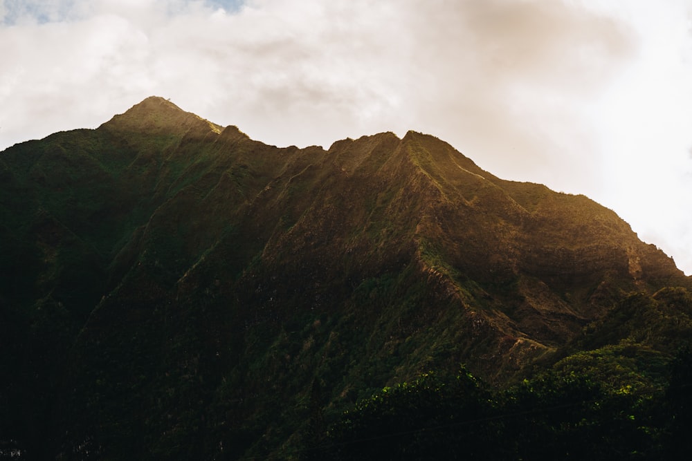 a very tall mountain with a sky in the background