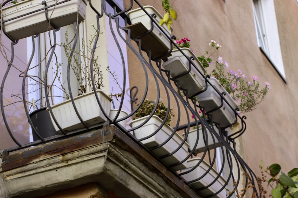 a balcony with a planter filled with flowers next to a building