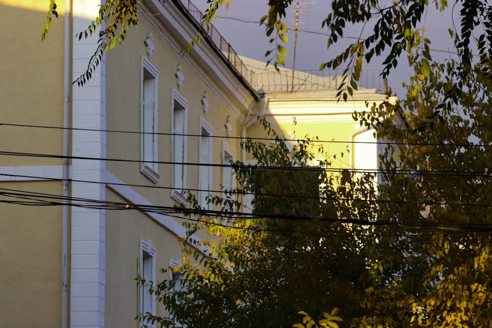 a view of a building through some power lines