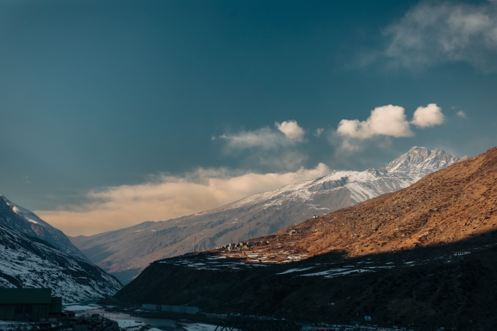 a snow covered mountain with a river running through it