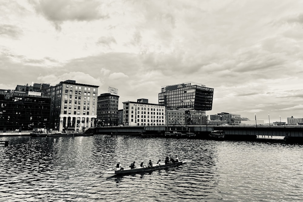 a group of people rowing a boat on a river