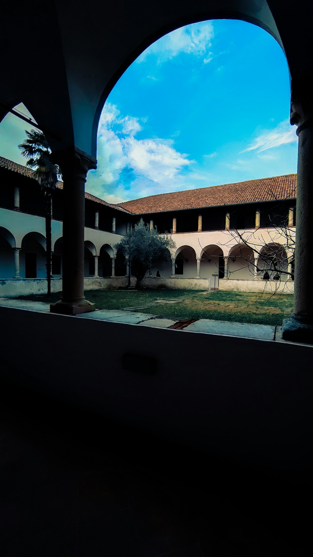 a view of a courtyard through an archway