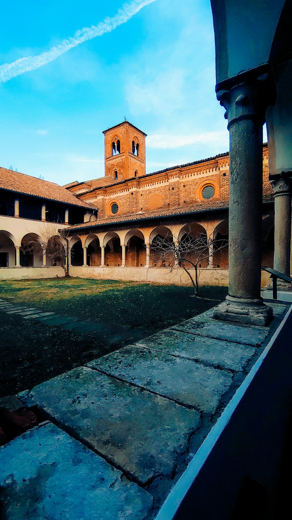 a courtyard with a clock tower in the background