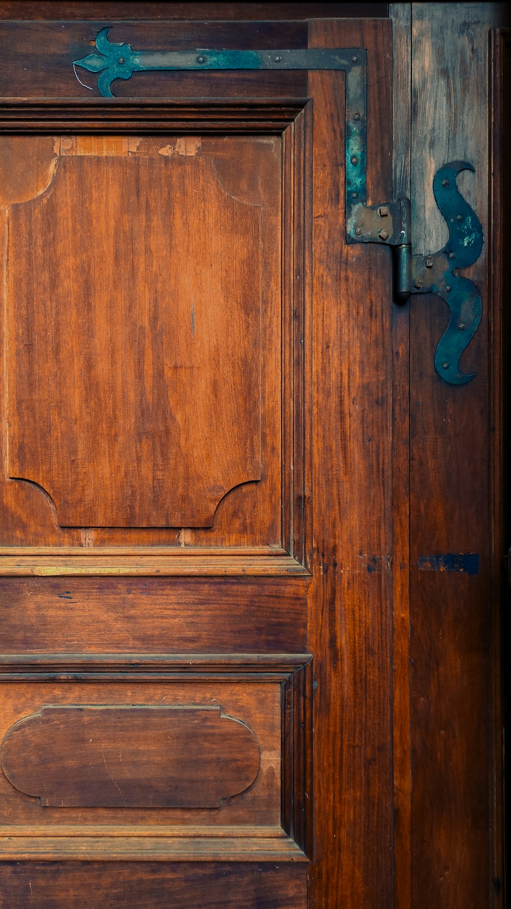 a close up of a wooden door with a metal handle