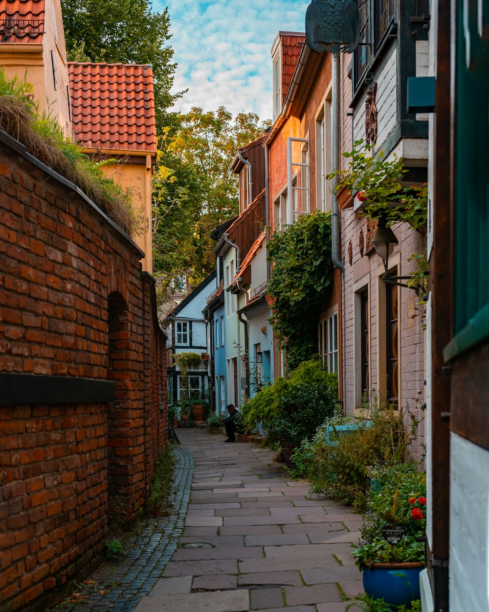 a cobblestone street lined with brick buildings