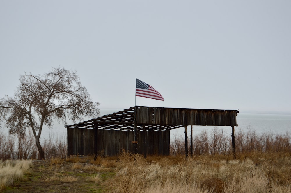 an american flag on top of a wooden structure