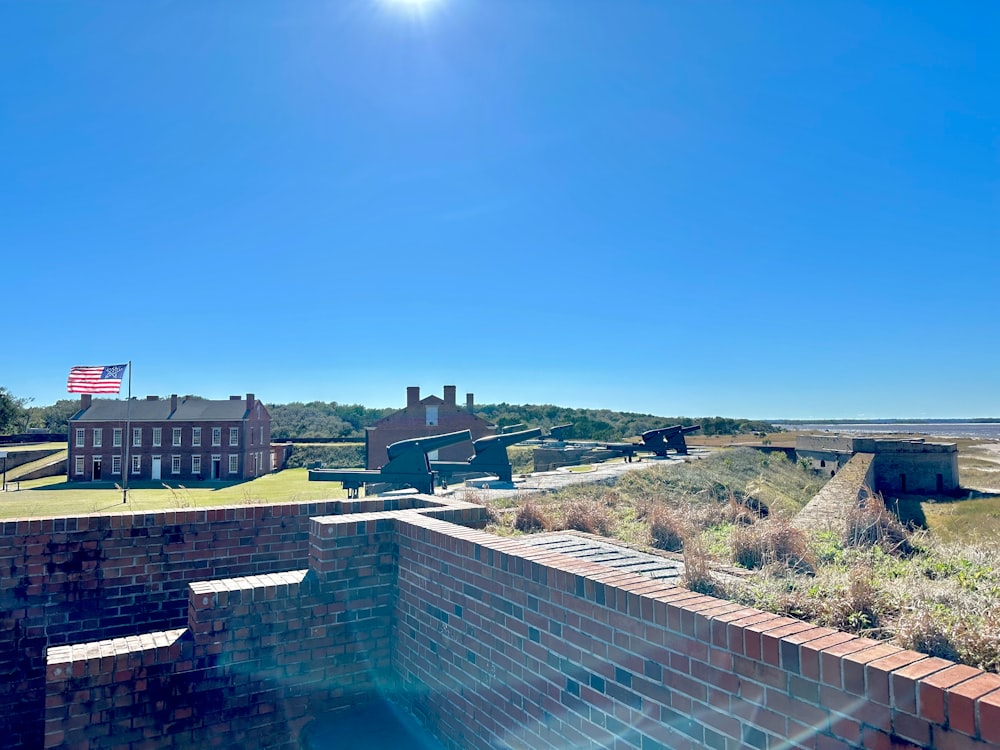 a brick wall with a flag on top of it