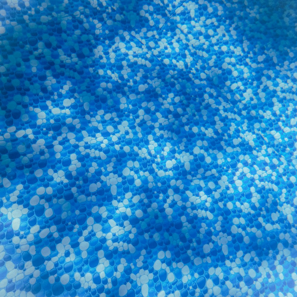 a close up of a blue and white rug