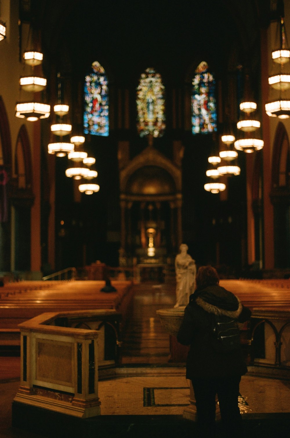 a person standing in front of a church with stained glass windows