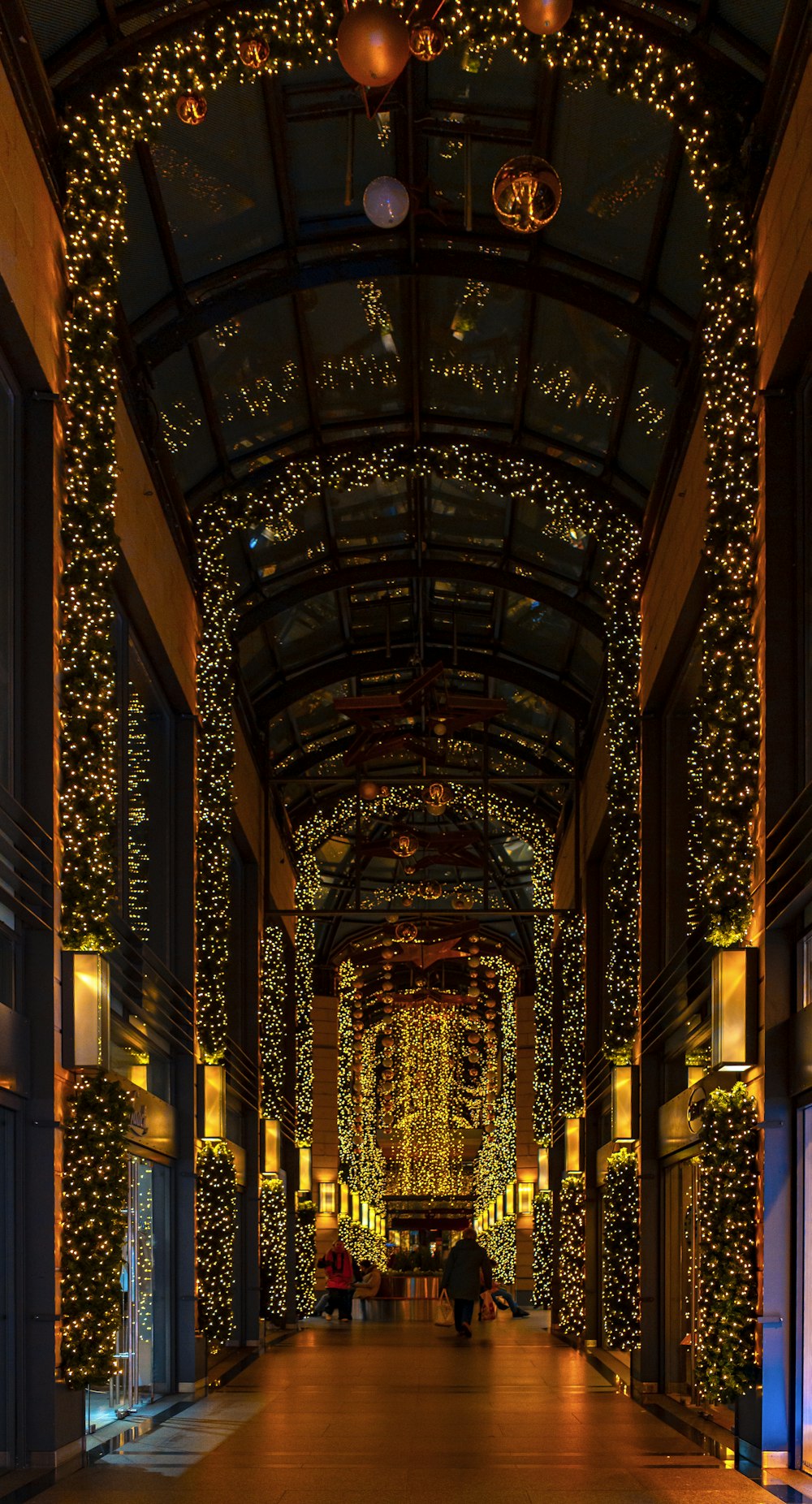 a long hallway with lights and decorations on the ceiling