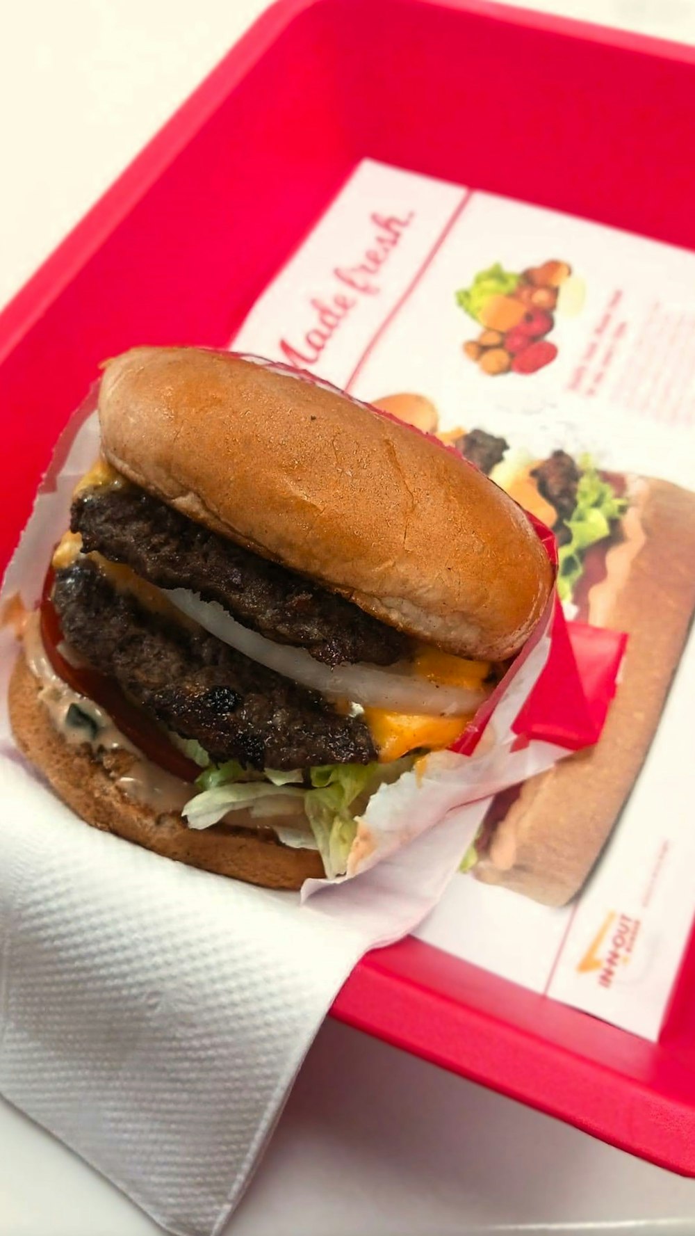 a hamburger sitting on top of a red tray