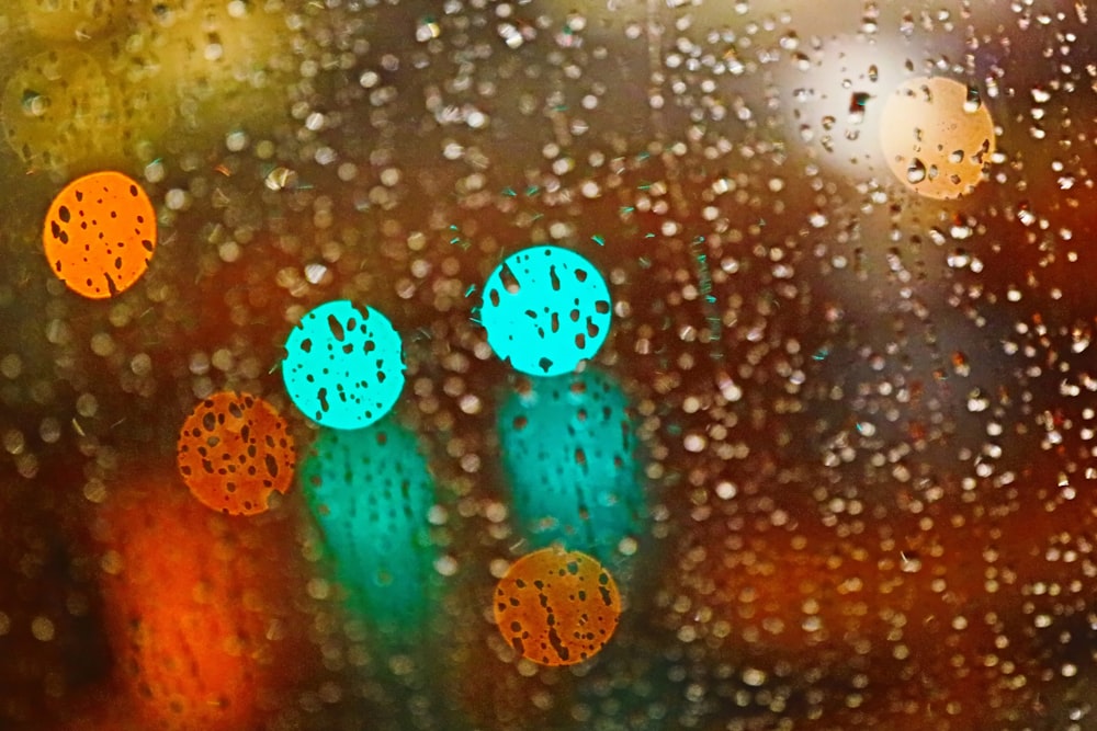 rain drops on a window with traffic lights in the background