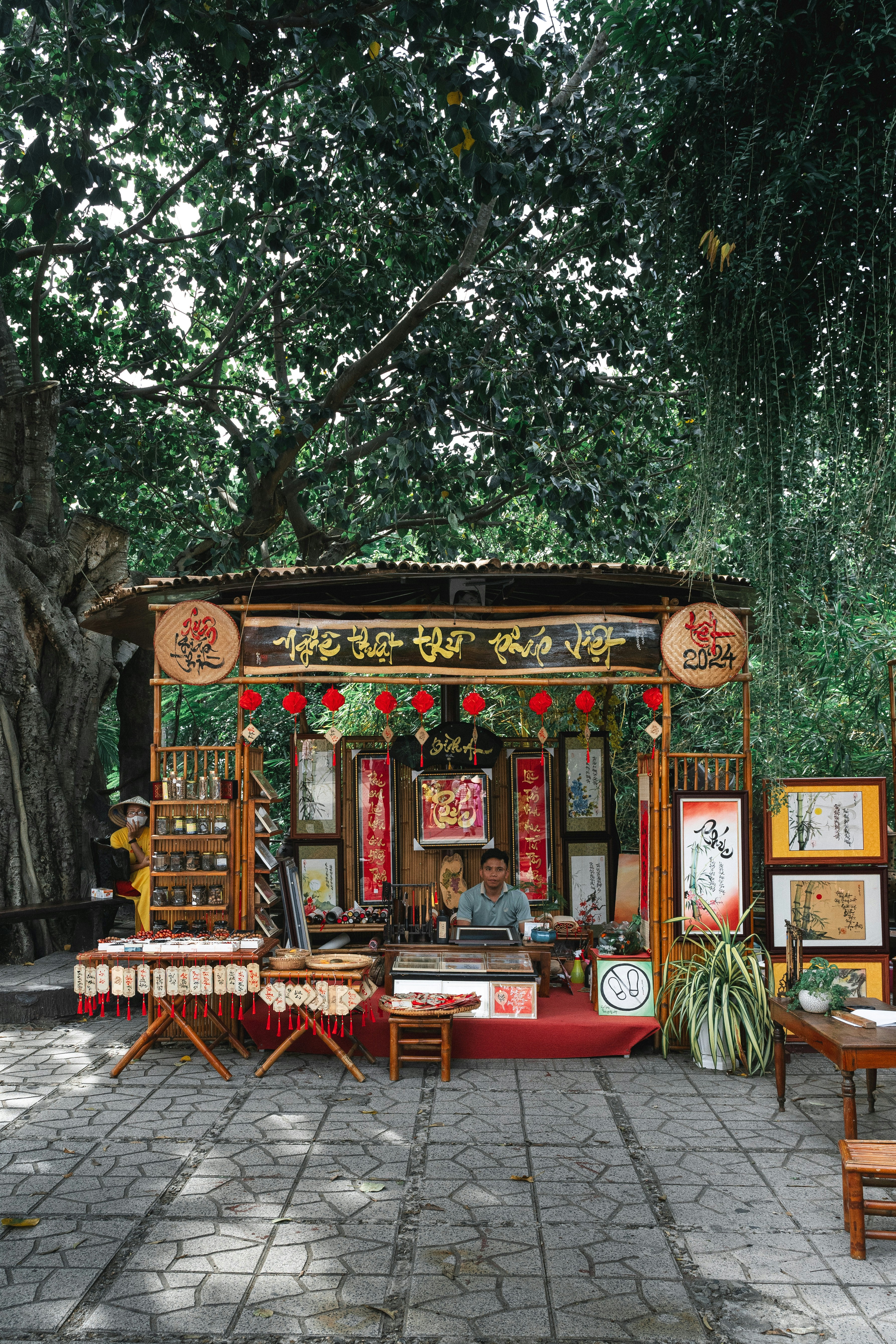 a man sitting at a table in front of a shrine
