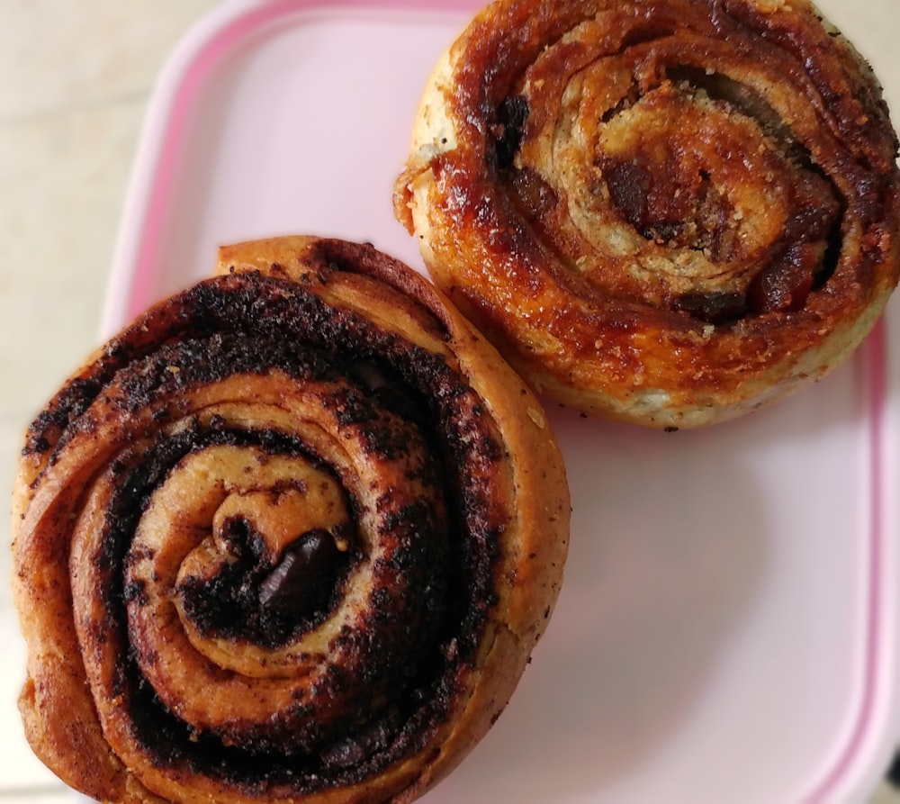 a close up of two pastries on a plate